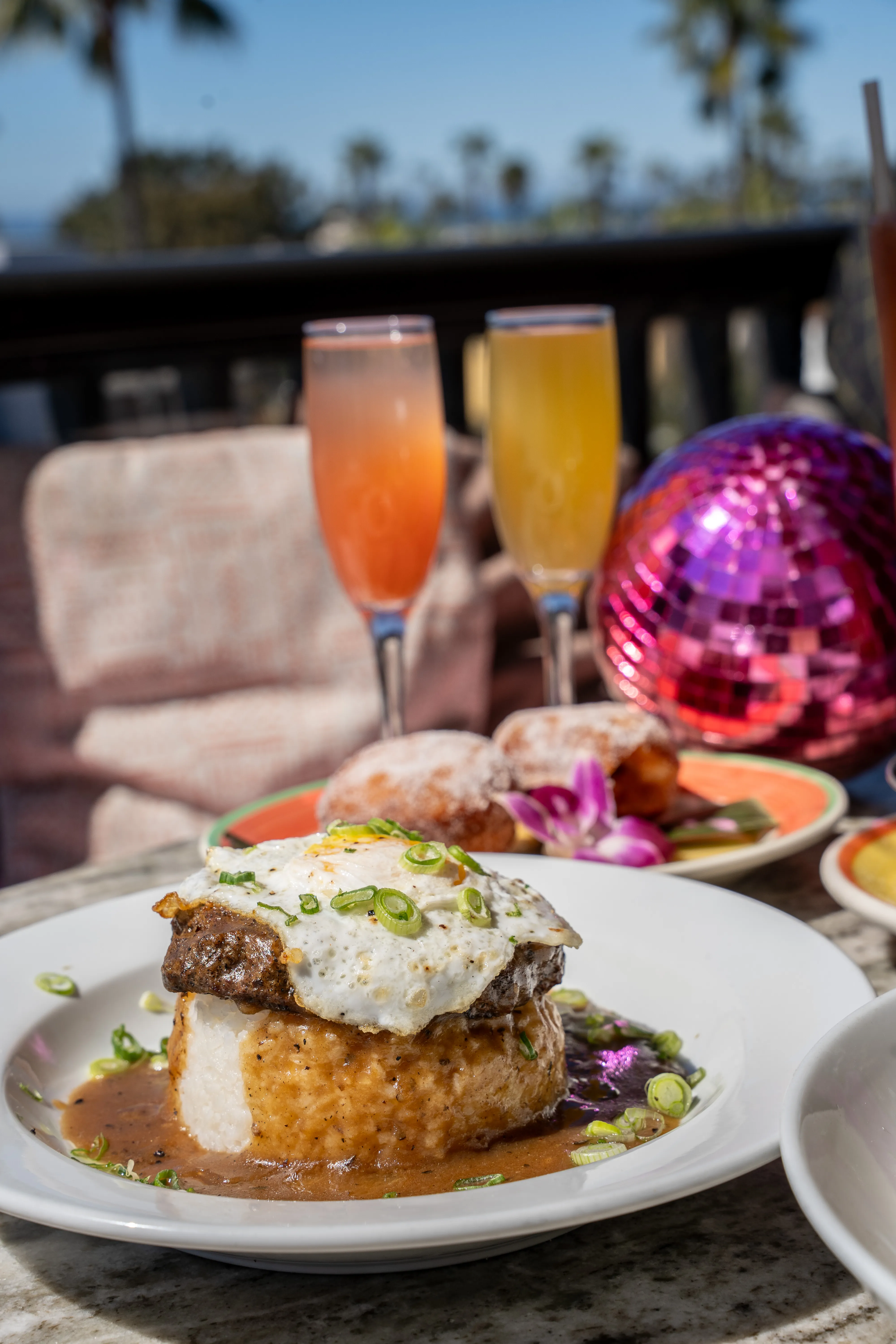 Biscuits and gravy with fried egg and green onion — rooftop brunch at Coco Cabana