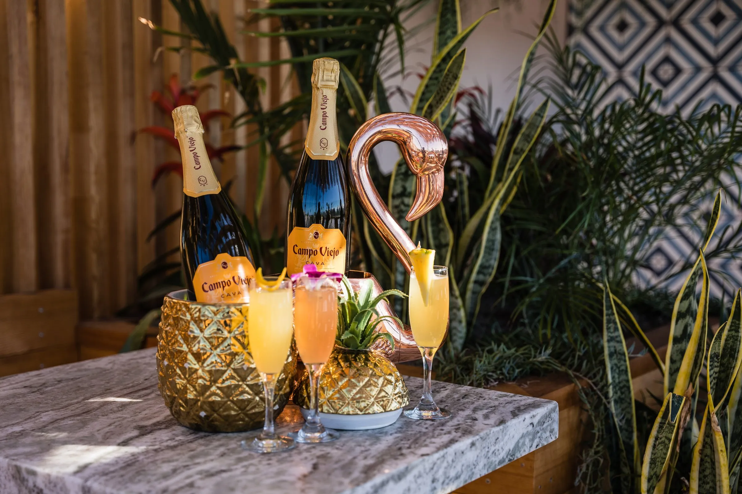Coco Cabana bottomless mimosas — Campo Viejo cava flights with copper flamingo, marble table, tile wall