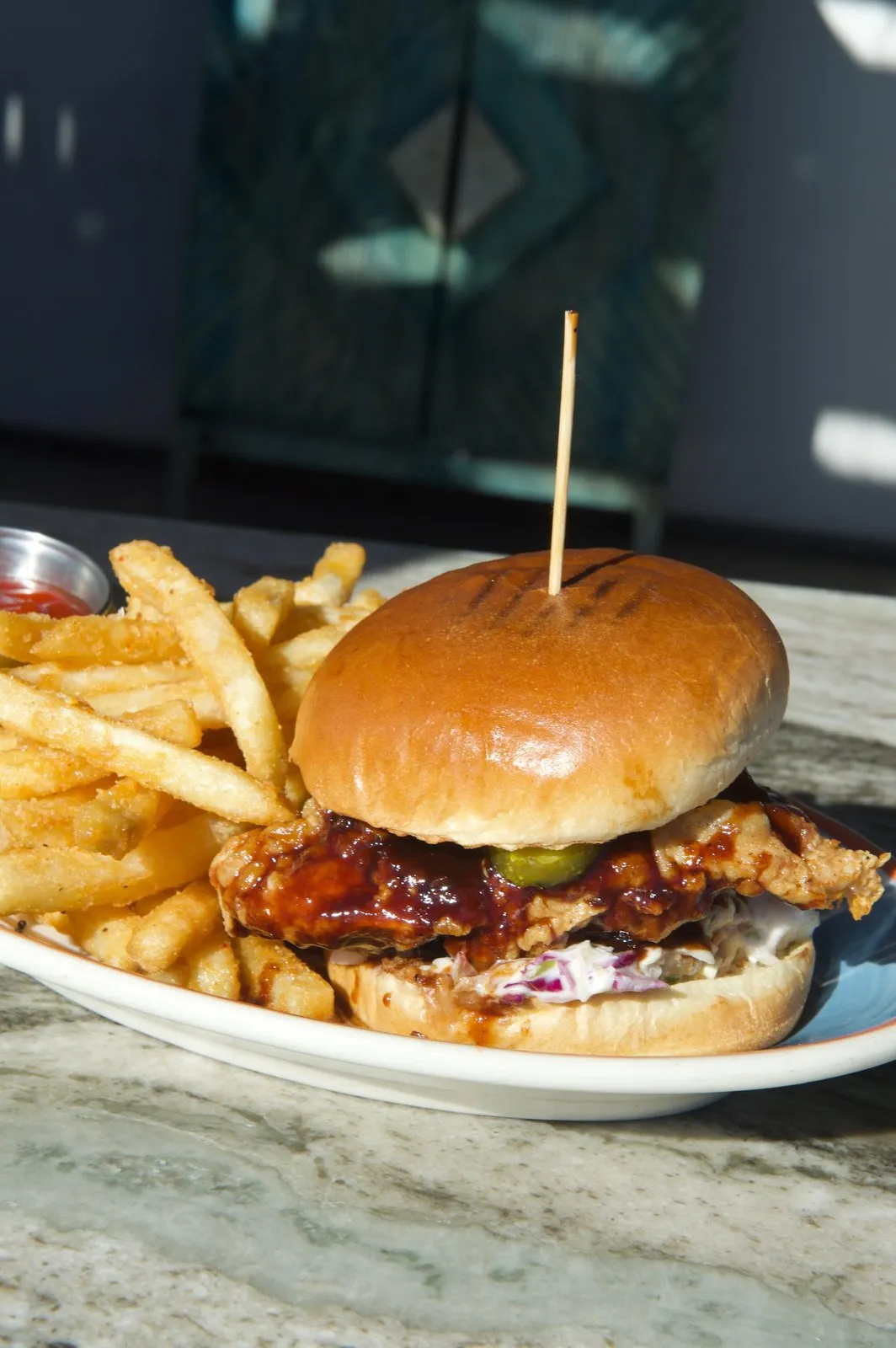 Crispy chicken sandwich with slaw and fries