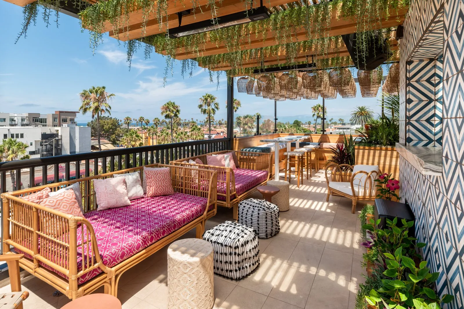 Coco Cabana rooftop lounge seating with tile wall, rattan pendants, and Oceanside views